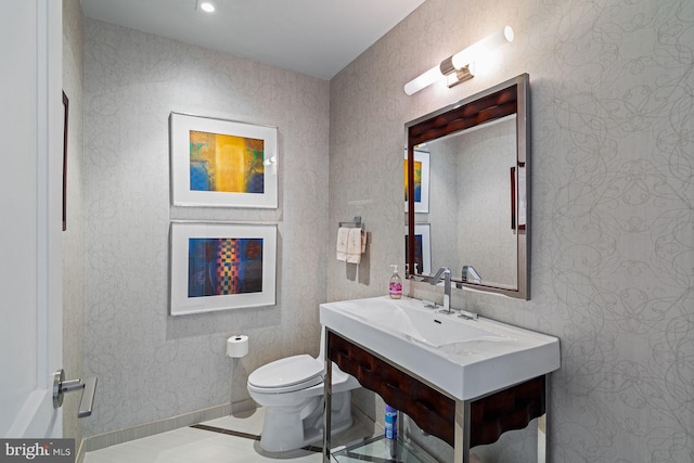 bathroom with vanity, toilet, and tile patterned floors