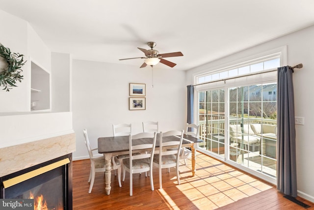 dining room with ceiling fan, visible vents, baseboards, and wood finished floors