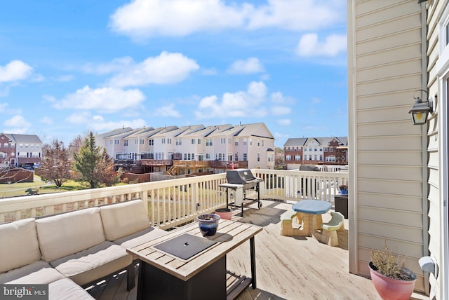 wooden deck with a residential view, an outdoor living space, and area for grilling