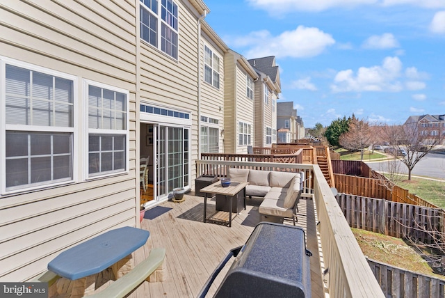 wooden deck with an outdoor living space, a residential view, and fence