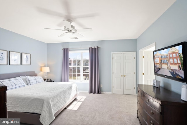 bedroom featuring light colored carpet, baseboards, and ceiling fan