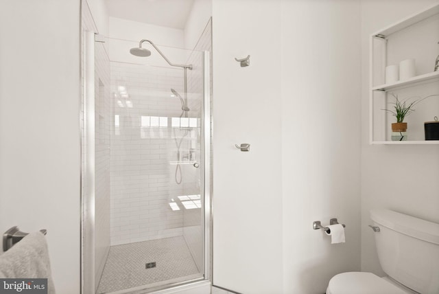 full bath with a stall shower and toilet