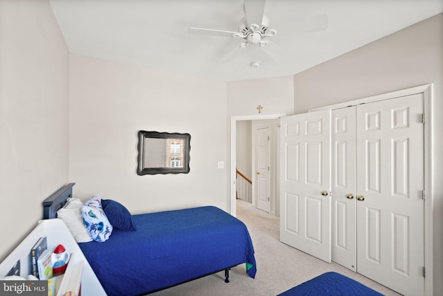 bedroom with light colored carpet, a closet, and ceiling fan