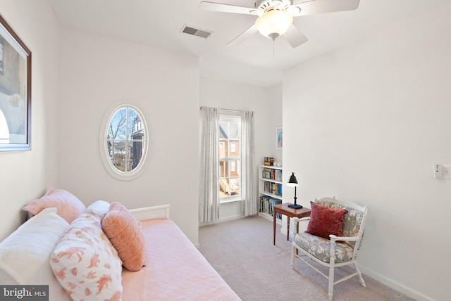 bedroom with visible vents, light carpet, baseboards, and a ceiling fan