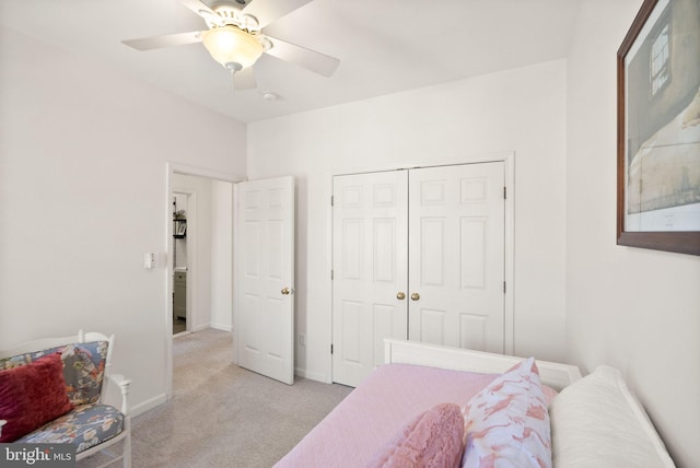 bedroom with baseboards, light carpet, a closet, and a ceiling fan