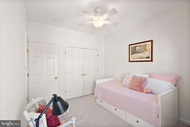 bedroom with a closet, carpet, and a ceiling fan