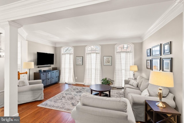 living room with crown molding, plenty of natural light, and wood finished floors