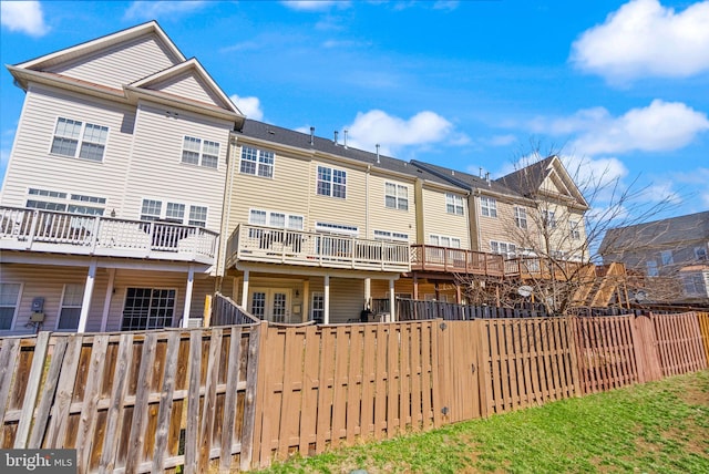 rear view of house featuring fence