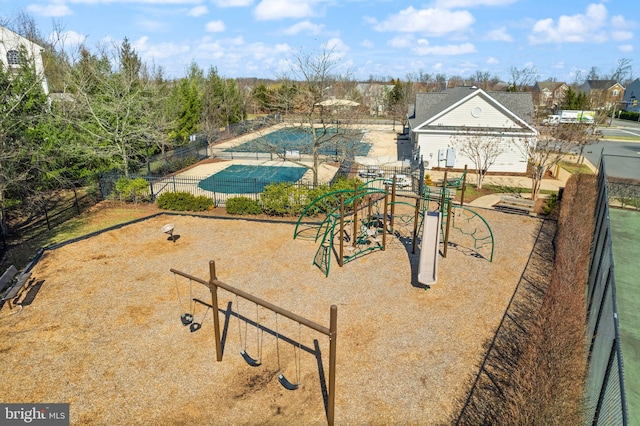 view of community featuring playground community and fence