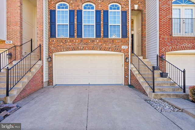 garage featuring concrete driveway