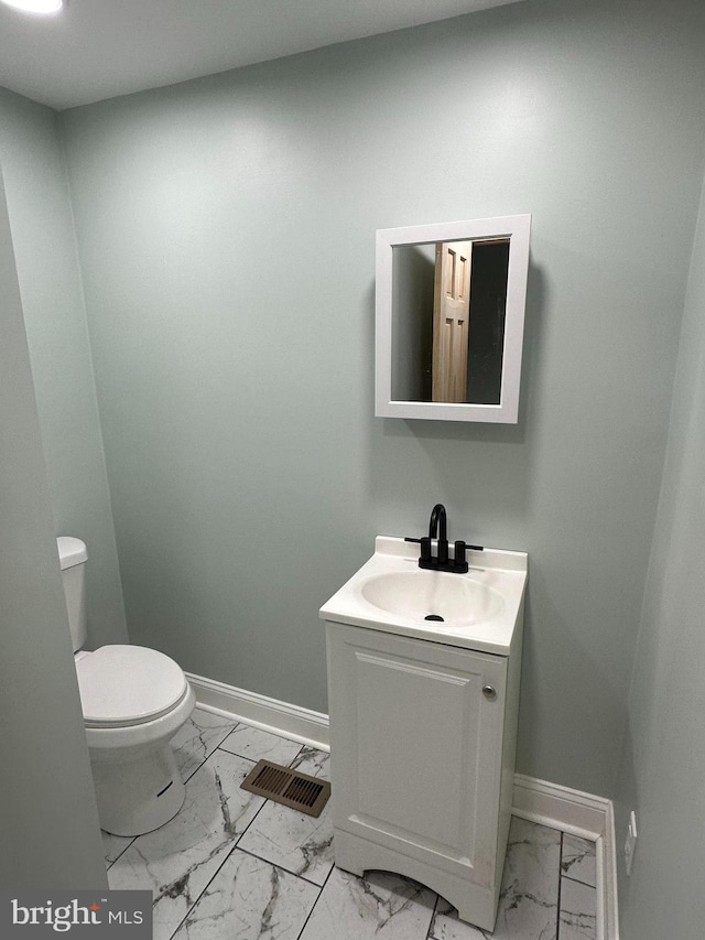 bathroom featuring vanity and toilet