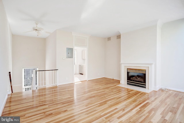 unfurnished living room featuring light wood-type flooring, electric panel, and ceiling fan