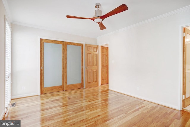 unfurnished bedroom featuring wood-type flooring, ceiling fan, and crown molding