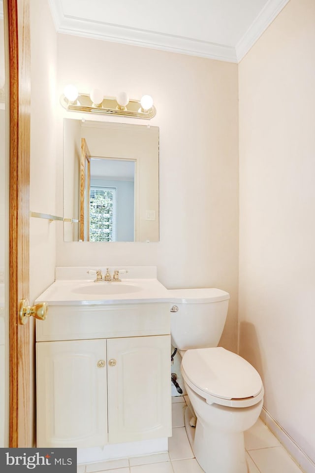 bathroom featuring vanity, tile patterned flooring, toilet, and ornamental molding