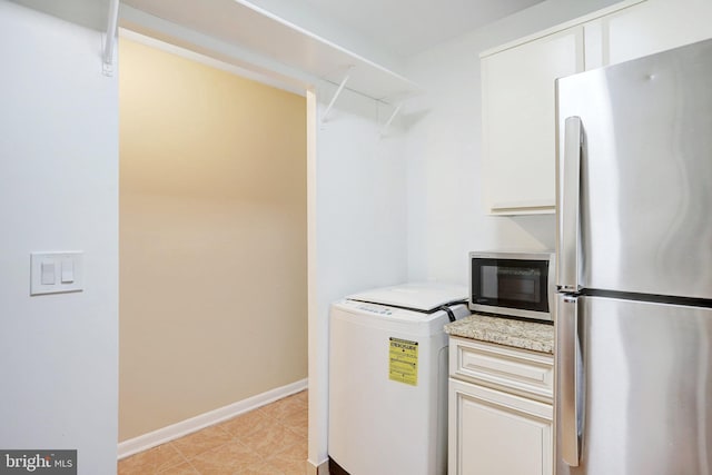 kitchen featuring white cabinets, washer / clothes dryer, and appliances with stainless steel finishes