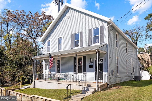 view of front of house with a porch, a front yard, and central air condition unit