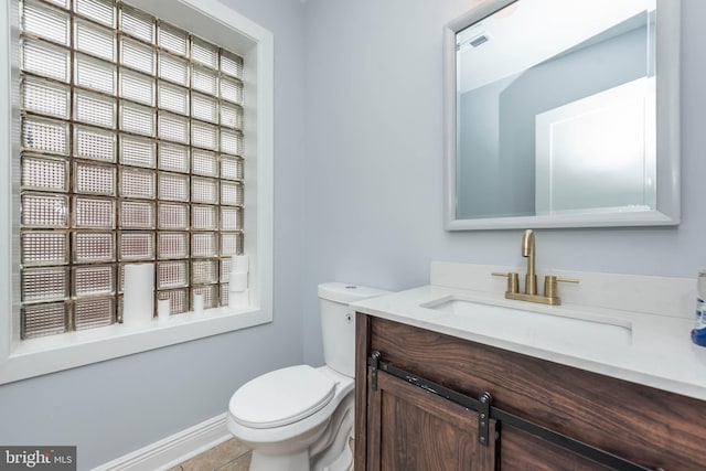 bathroom with tile patterned floors, vanity, and toilet