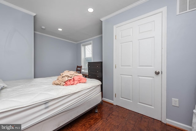 bedroom featuring dark hardwood / wood-style floors and crown molding