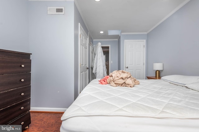 bedroom featuring dark wood-type flooring and crown molding