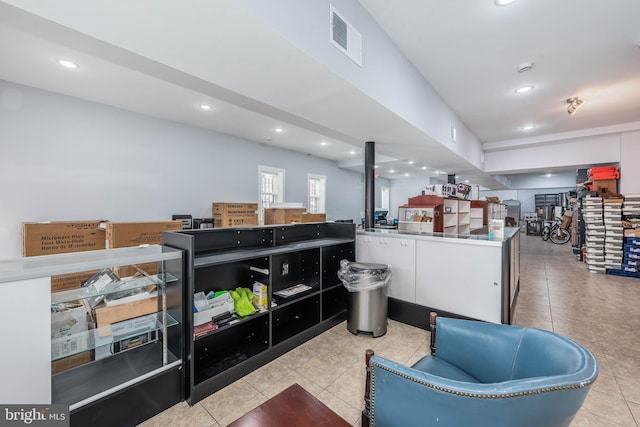 interior space with white cabinetry and light tile patterned floors