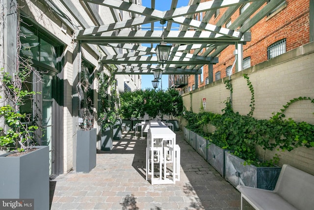 view of patio / terrace featuring a pergola and exterior bar