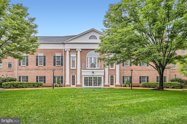 view of front of home with a front yard and french doors