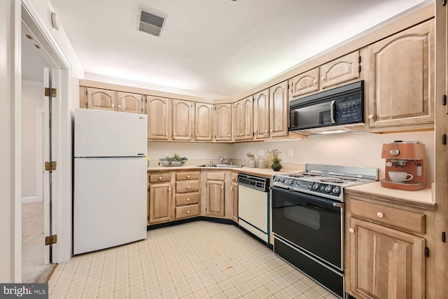 kitchen featuring white appliances, light brown cabinetry, and sink