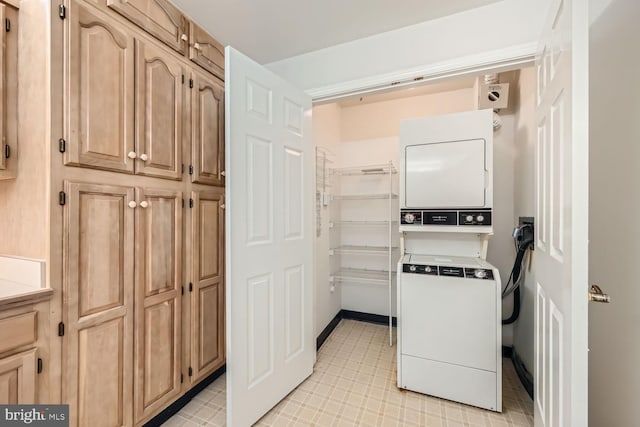 kitchen featuring light brown cabinetry and stacked washer / dryer