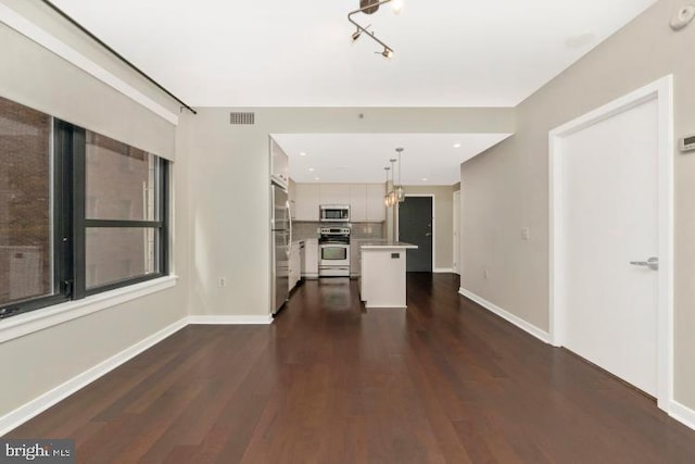 unfurnished living room with dark wood-type flooring