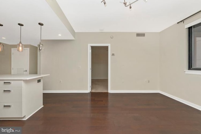 unfurnished living room with dark wood-type flooring