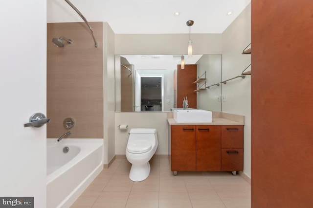 full bathroom featuring tiled shower / bath, vanity, tile patterned flooring, and toilet