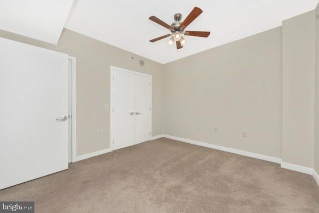 unfurnished bedroom featuring ceiling fan and light carpet