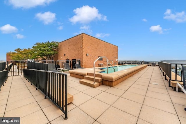 view of swimming pool with a patio