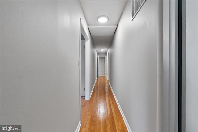 corridor with light hardwood / wood-style floors