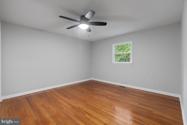 empty room featuring ceiling fan and hardwood / wood-style flooring