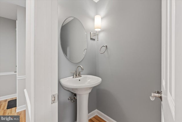 bathroom with wood-type flooring and sink