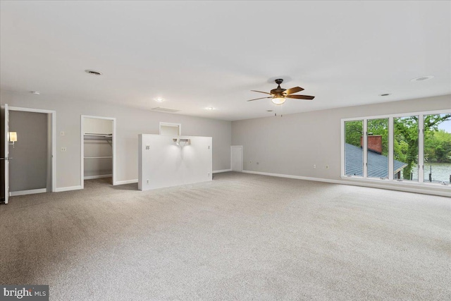 interior space featuring light carpet and ceiling fan