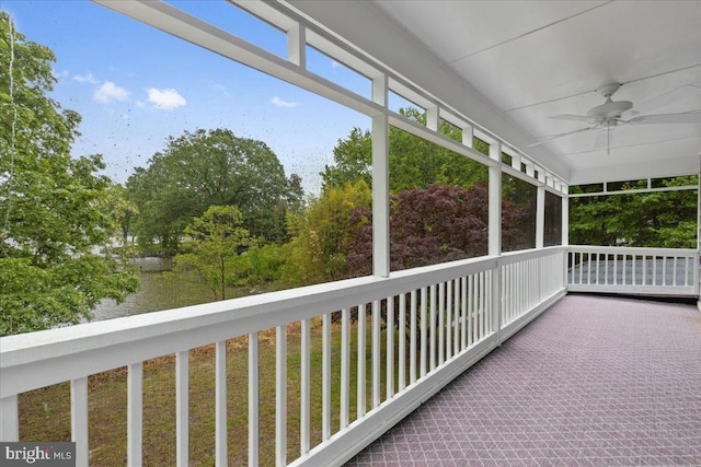 unfurnished sunroom featuring ceiling fan