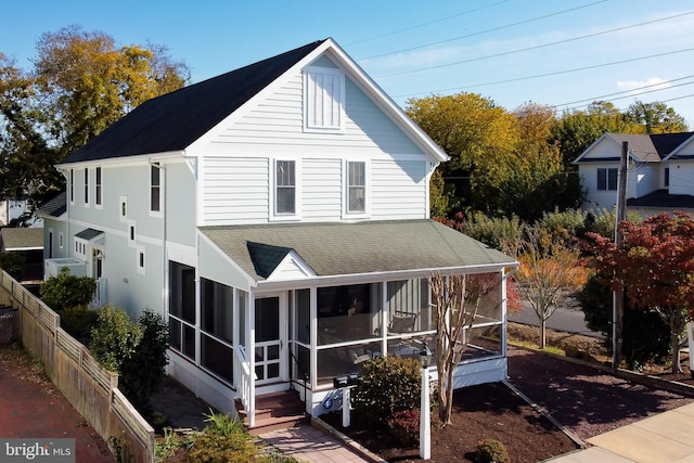 view of front of home featuring a sunroom