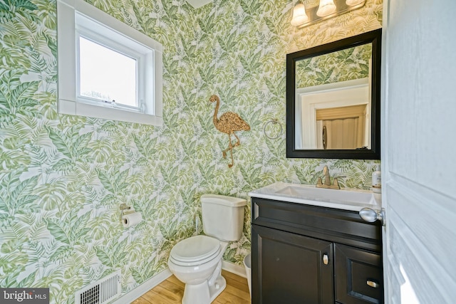 bathroom with vanity, hardwood / wood-style floors, and toilet