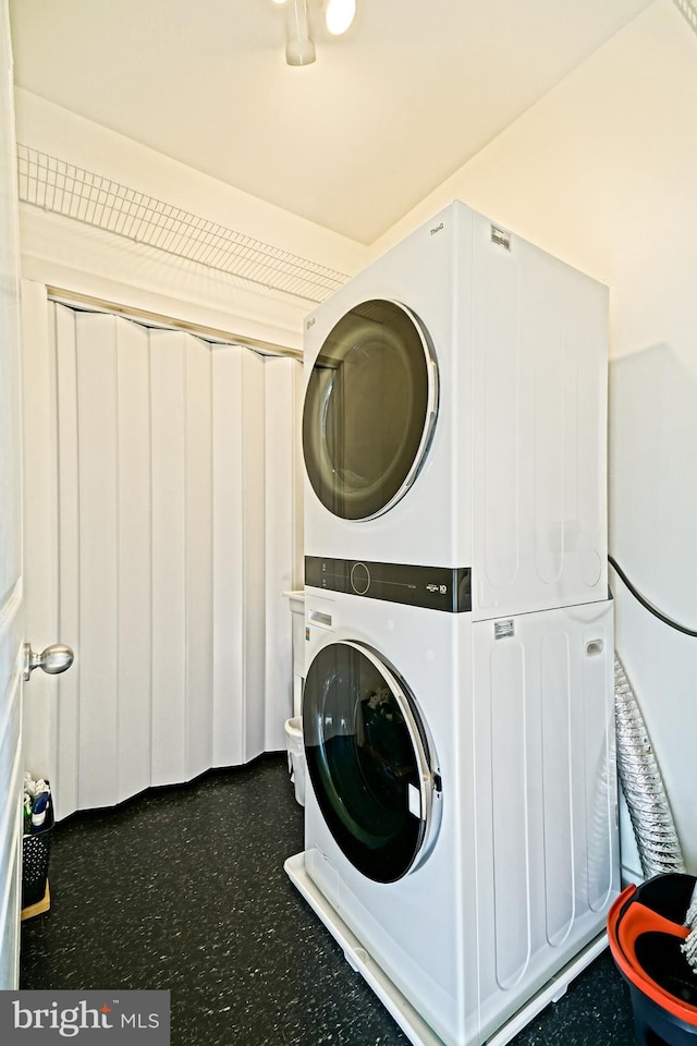 laundry room with stacked washer and clothes dryer