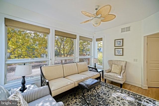 interior space with ceiling fan and wood-type flooring