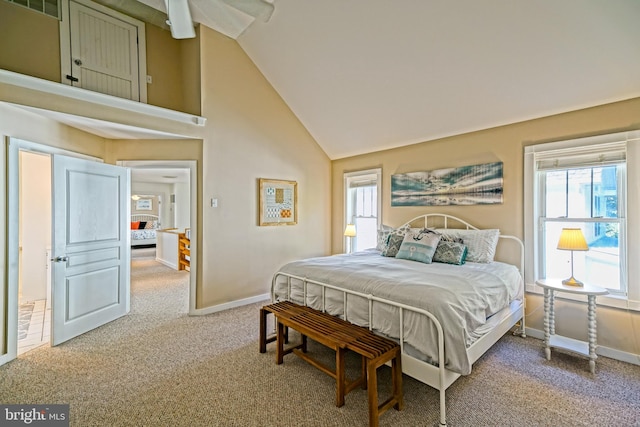 bedroom with carpet, multiple windows, and high vaulted ceiling