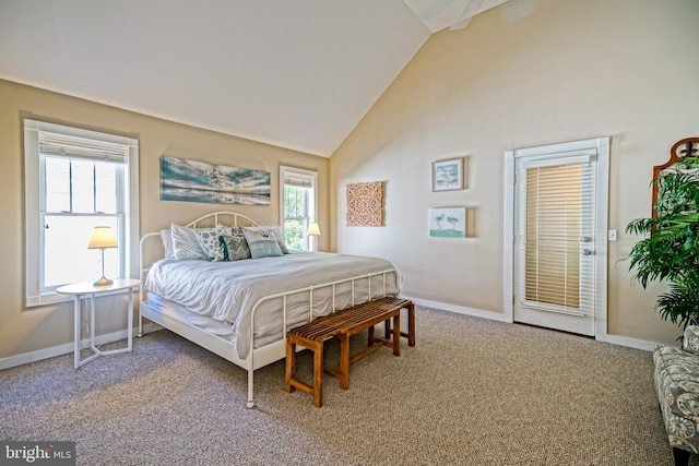 carpeted bedroom featuring multiple windows and high vaulted ceiling