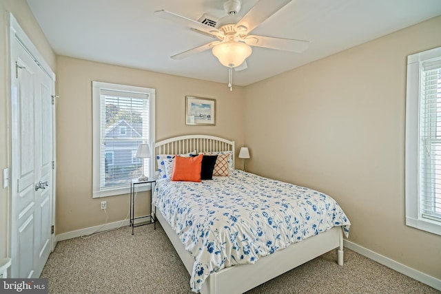 carpeted bedroom featuring a closet and ceiling fan