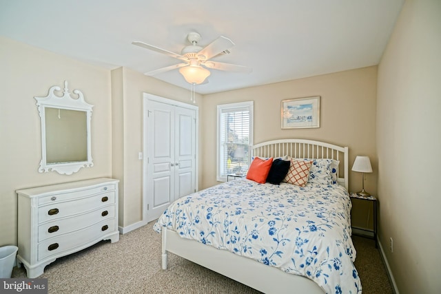 carpeted bedroom featuring a closet and ceiling fan