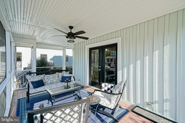 wooden deck featuring an outdoor hangout area and ceiling fan