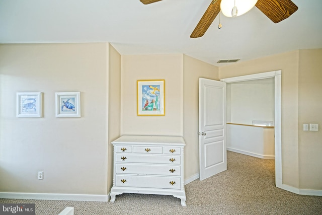 unfurnished bedroom with light colored carpet and ceiling fan