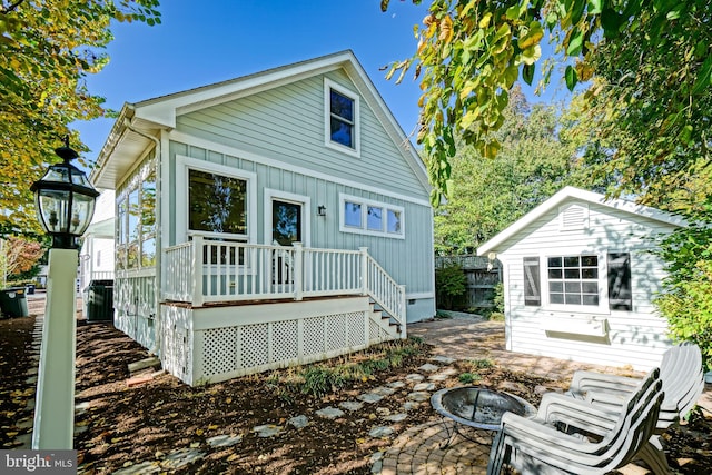 back of house featuring a fire pit