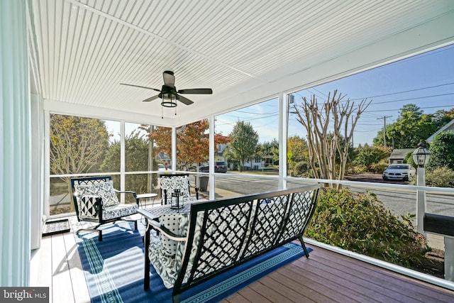 sunroom featuring a healthy amount of sunlight and ceiling fan